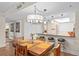 Open-concept dining area with wood flooring, a modern light fixture, and seating for four at 530 E Central Blvd # 303, Orlando, FL 32801