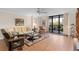 Inviting condo living room featuring a cozy sofa, stylish furniture, and access to a private balcony at 530 E Central Blvd # 303, Orlando, FL 32801