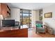 Bright office with wood desk, chair, shelving and balcony access with large sliding doors at 530 E Central Blvd # 303, Orlando, FL 32801