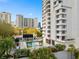 Beautiful community pool and lounge area with surrounding palm trees offering a relaxing oasis at 530 E Central Blvd # 303, Orlando, FL 32801