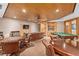 A spacious recreation room with billiards, seating areas, and built in bookcases at 530 E Central Blvd # 303, Orlando, FL 32801
