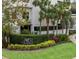 Well-manicured entrance to '530 East Central' with lush greenery and colorful landscaping, creating an inviting approach at 530 E Central Blvd # 303, Orlando, FL 32801
