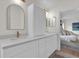 Bright bathroom featuring double sinks, white cabinets and brushed gold plumbing fixtures at 5425 Bryce Canyon Dr, Kissimmee, FL 34758