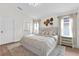 Bright main bedroom featuring hardwood floors, neutral walls, and a king bed with decorative pillows at 5425 Bryce Canyon Dr, Kissimmee, FL 34758