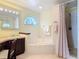 Bathroom featuring a jetted tub, walk-in shower, and vanity with a lit mirror at 554 Queensbridge Dr, Lake Mary, FL 32746