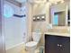 Tastefully designed bathroom with a shower-tub combination and a decorative stained glass window at 554 Queensbridge Dr, Lake Mary, FL 32746