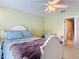 Bedroom features an ensuite bathroom, a ceiling fan, and light-yellow walls at 554 Queensbridge Dr, Lake Mary, FL 32746