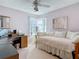 Bedroom features a ceiling fan, desk, and a daybed with white bedding and pillows at 554 Queensbridge Dr, Lake Mary, FL 32746
