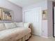 Bedroom features a double sliding-door closet and mirrored wall decor above the daybed at 554 Queensbridge Dr, Lake Mary, FL 32746