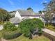 Charming exterior view of a residence highlighting the mature trees and lush greenery of the front yard at 554 Queensbridge Dr, Lake Mary, FL 32746