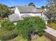 Rear view of home, showcasing the well-kept exterior with mature trees and lush landscaping at 554 Queensbridge Dr, Lake Mary, FL 32746