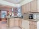 Open kitchen area with granite countertops and tile backsplash, seamlessly connecting to a stylish dining room at 554 Queensbridge Dr, Lake Mary, FL 32746