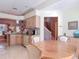 Cozy kitchen nook with a round table, views of stairs to second floor, and tiled floors, creating a bright and inviting space at 554 Queensbridge Dr, Lake Mary, FL 32746