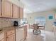 Cozy kitchen nook with a round table, window shutters, and tiled floors, creating a bright and inviting space at 554 Queensbridge Dr, Lake Mary, FL 32746