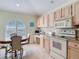 Charming kitchen nook with arched window, granite counters and table, creating a bright and inviting space at 554 Queensbridge Dr, Lake Mary, FL 32746