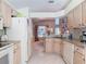 Bright kitchen with stainless steel appliances flowing into an adjacent dining room, ideal for modern living at 554 Queensbridge Dr, Lake Mary, FL 32746