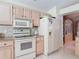 Bright kitchen with stainless steel appliances and view of hutch and dining room, ideal for modern living at 554 Queensbridge Dr, Lake Mary, FL 32746