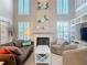 Cozy living room with a fireplace, plantation shutters, and ample seating, perfect for relaxing or entertaining at 554 Queensbridge Dr, Lake Mary, FL 32746