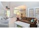 Open-concept living room with views of the kitchen, dining area, and natural light throughout the home at 554 Queensbridge Dr, Lake Mary, FL 32746