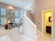 Bright living room with high ceilings, plantation shutters, fireplace and staircase to the upper level at 554 Queensbridge Dr, Lake Mary, FL 32746