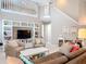 Bright, open living area with built in shelving, a staircase, and a cozy seating area at 554 Queensbridge Dr, Lake Mary, FL 32746