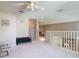 Upstairs loft area with neutral paint, plush carpeting, and white staircase railing at 554 Queensbridge Dr, Lake Mary, FL 32746