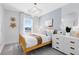 Comfortable bedroom with a bed, accent wall, and a sunny window at 6394 Tabebuia Pkwy, Winter Garden, FL 34787