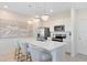 Modern kitchen with stainless steel appliances, white cabinetry, a quartz countertop island and pendant lighting at 6394 Tabebuia Pkwy, Winter Garden, FL 34787