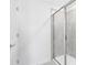 Modern shower with light gray tiling and a frameless glass door at 6394 Tabebuia Pkwy, Winter Garden, FL 34787