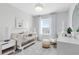 Bright baby's bedroom features a light colored crib, rocking chair, and carpet at 6424 Tabebuia Pkwy, Winter Garden, FL 34787