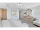 Bright bedroom features neutral decor, modern dresser, and decorative round mirror at 6424 Tabebuia Pkwy, Winter Garden, FL 34787