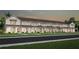 New construction townhomes featuring craftsman-style architecture, covered entries, and lush landscaping at 6424 Tabebuia Pkwy, Winter Garden, FL 34787