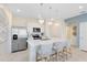 Modern kitchen with white cabinets, stainless steel appliances, a center island and pendant lighting at 6424 Tabebuia Pkwy, Winter Garden, FL 34787