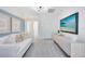 Bright living room features a modern light fixture, light gray carpet, and a flat screen television at 6424 Tabebuia Pkwy, Winter Garden, FL 34787