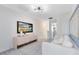 Bright living room features a modern light fixture, light gray carpet, and a flat screen television at 6424 Tabebuia Pkwy, Winter Garden, FL 34787