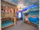 An imaginatively designed bedroom with a Moana theme that includes a boat bed and wave mural at 7464 Gathering Dr, Reunion, FL 34747