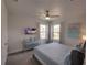 Bright bedroom with a blue bed, flat screen TV, and two windows providing natural light at 7464 Gathering Dr, Reunion, FL 34747