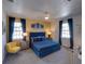 Well-lit primary bedroom showcasing a blue bed set and stylish decor in a modern home at 7464 Gathering Dr, Reunion, FL 34747