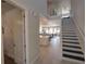 Entryway featuring tile floors, a staircase, and an open view to the living spaces at 7464 Gathering Dr, Reunion, FL 34747