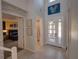 Bright and airy foyer featuring tile floors, staircase, and doorway to bedroom and bathroom at 7464 Gathering Dr, Reunion, FL 34747