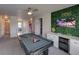 Upstairs game room with a pool table, bar, and a fun accent wall with lighting at 7464 Gathering Dr, Reunion, FL 34747