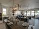 Open-concept living and dining area with modern furniture and a view of the pool at 7464 Gathering Dr, Reunion, FL 34747