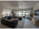 Spacious living room with stylish furnishings, tile floors, and sliding glass doors to the pool area at 7464 Gathering Dr, Reunion, FL 34747