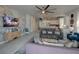 Open living room with decorative wall, modern furnishings, and view into the kitchen and dining room at 7464 Gathering Dr, Reunion, FL 34747