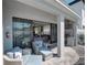 Comfortable outdoor seating with a view to a fully equipped outdoor kitchen and open living space at 7464 Gathering Dr, Reunion, FL 34747