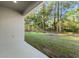Covered patio offers views of the lush, private backyard and mature trees at 8015 Sw 133Rd Ln, Ocala, FL 34473