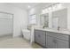 Bathroom features a soaking tub, gray vanity with double sinks, white countertop, and tile flooring at 8015 Sw 133Rd Ln, Ocala, FL 34473