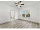 Inviting bedroom with a ceiling fan, light gray floors and large window at 8015 Sw 133Rd Ln, Ocala, FL 34473