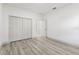 Bedroom featuring a closet with bi-fold doors, light grey laminate flooring and white walls at 8015 Sw 133Rd Ln, Ocala, FL 34473