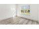 Bright bedroom showcasing neutral walls, laminate floors and large window offering ample natural light at 8015 Sw 133Rd Ln, Ocala, FL 34473